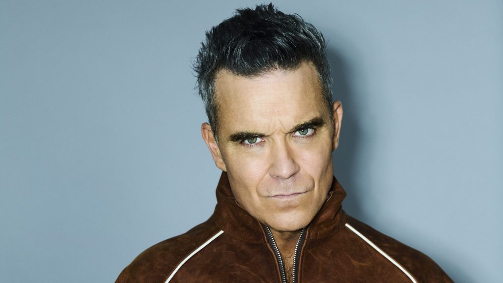 Robbie Williams míří na Colours 2027. 👑 Ostravo, připrav se. 💛 - Colours of Ostrava